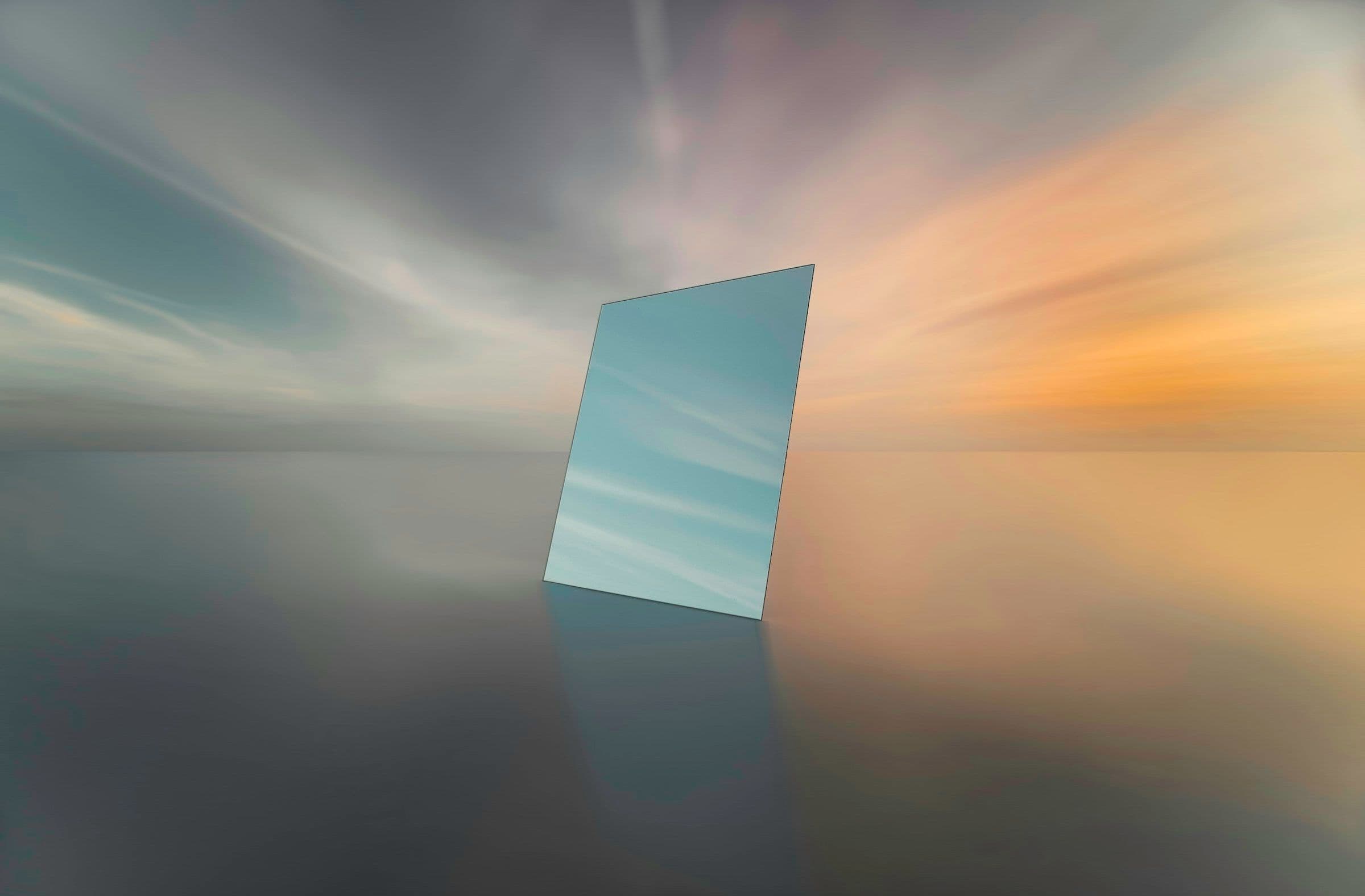 A single mirror standing upright on still water, reflecting the sky at dusk